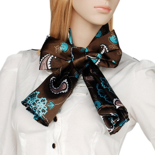 Brown silk scarf with teal paisley floral print, tied bow at collar