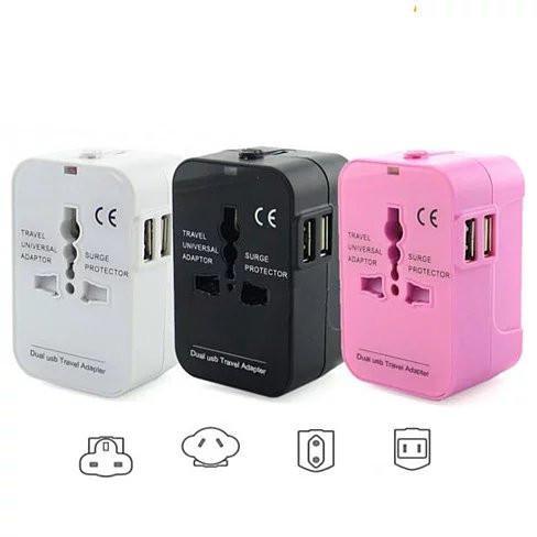 Compact travel universal power adapter set with dual USB, shown in white, black, pink.