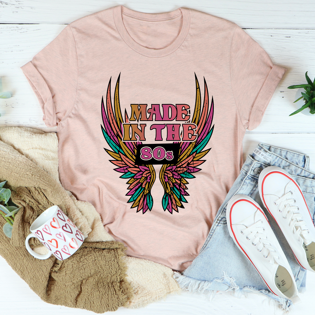 Blush pink crew-neck graphic T-shirt with 'Made in the 80s' winged emblem