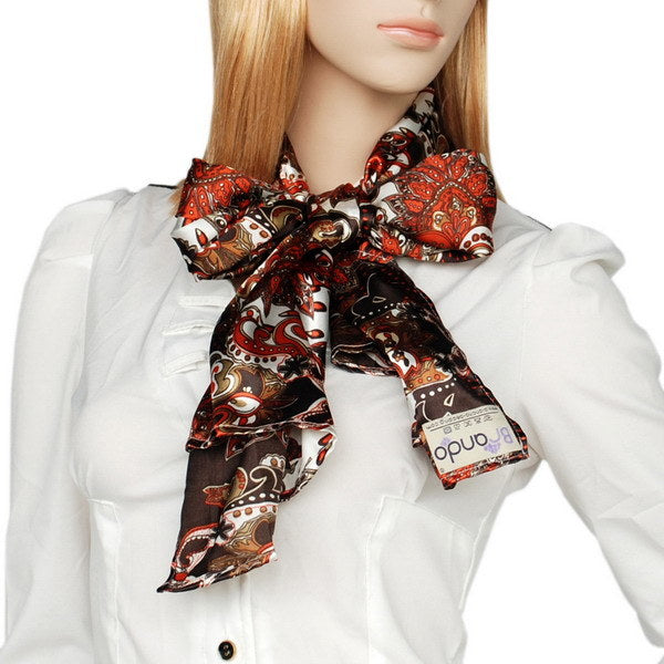 Paisley silk scarf tied at neck, dark brown with red and cream paisley, with tag