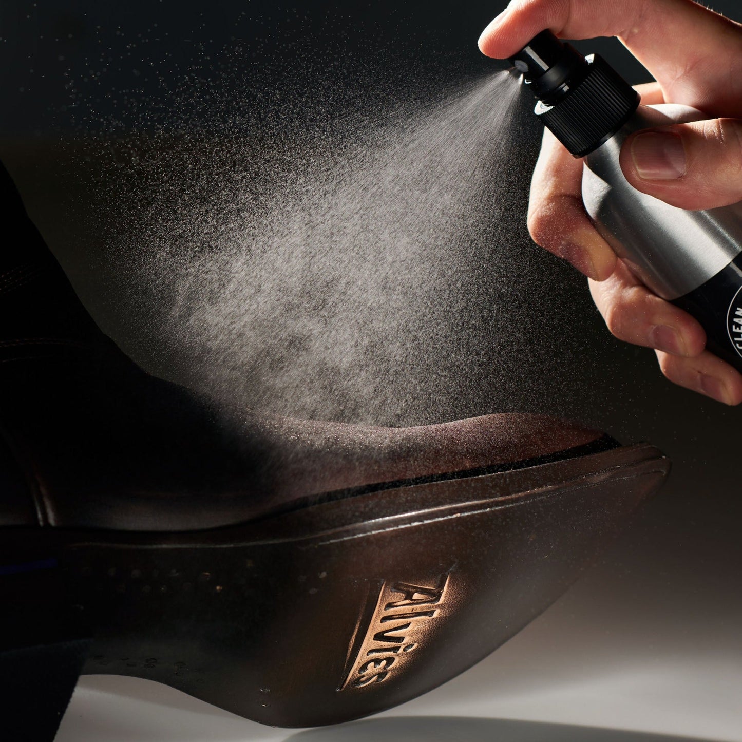 Leather conditioner misting dark leather boot toe