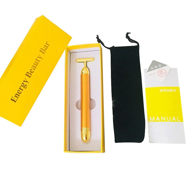 Gold facial roller massager kit with yellow packaging, black pouch, and manual