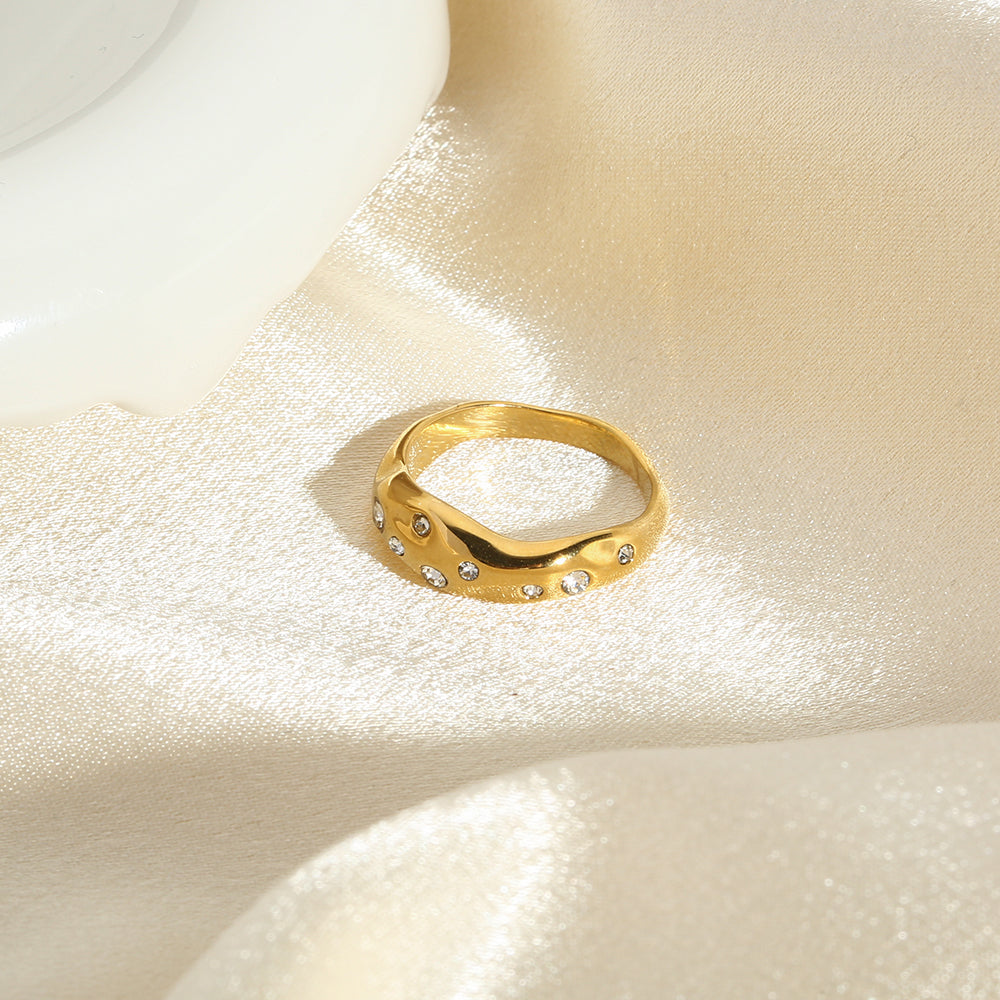 Gold snake-shape ring with clear stones, diagonal side view