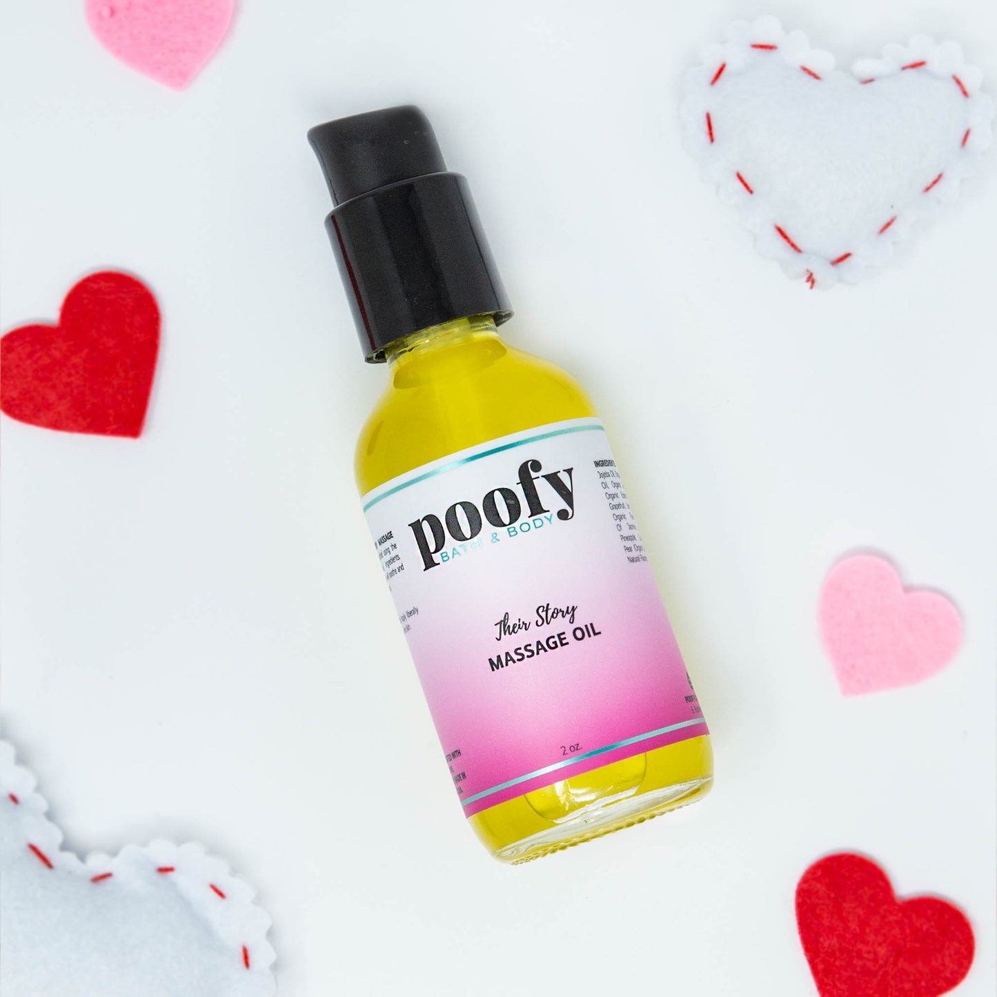 Massage oil bottle with black pump and pink-to-yellow label, standing upright.