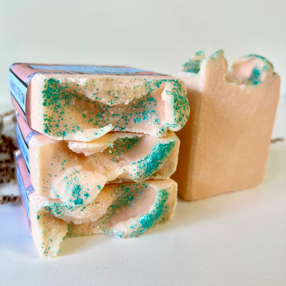 Sea salt soap bar stack with teal speckles and a second bar, side view