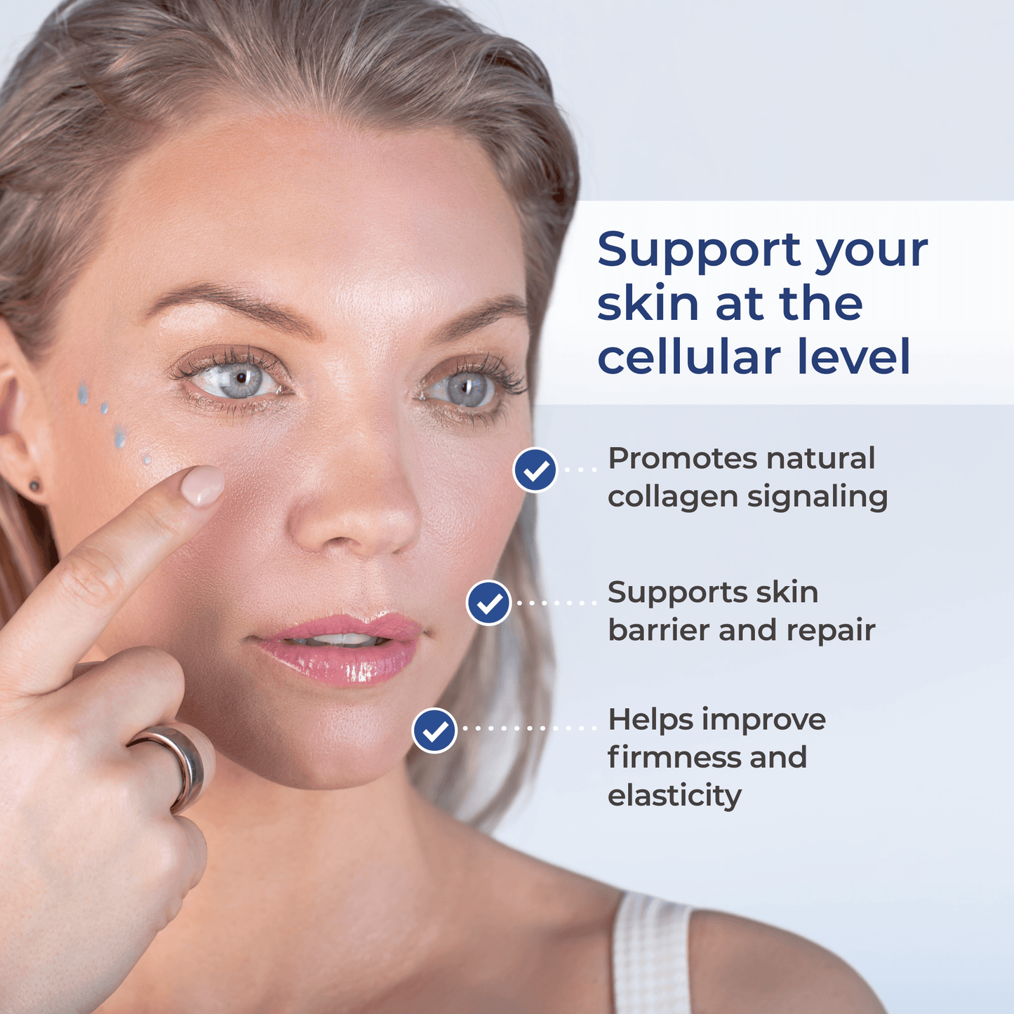 Face serum applied on a woman’s cheek with blue gel droplets near the eye area