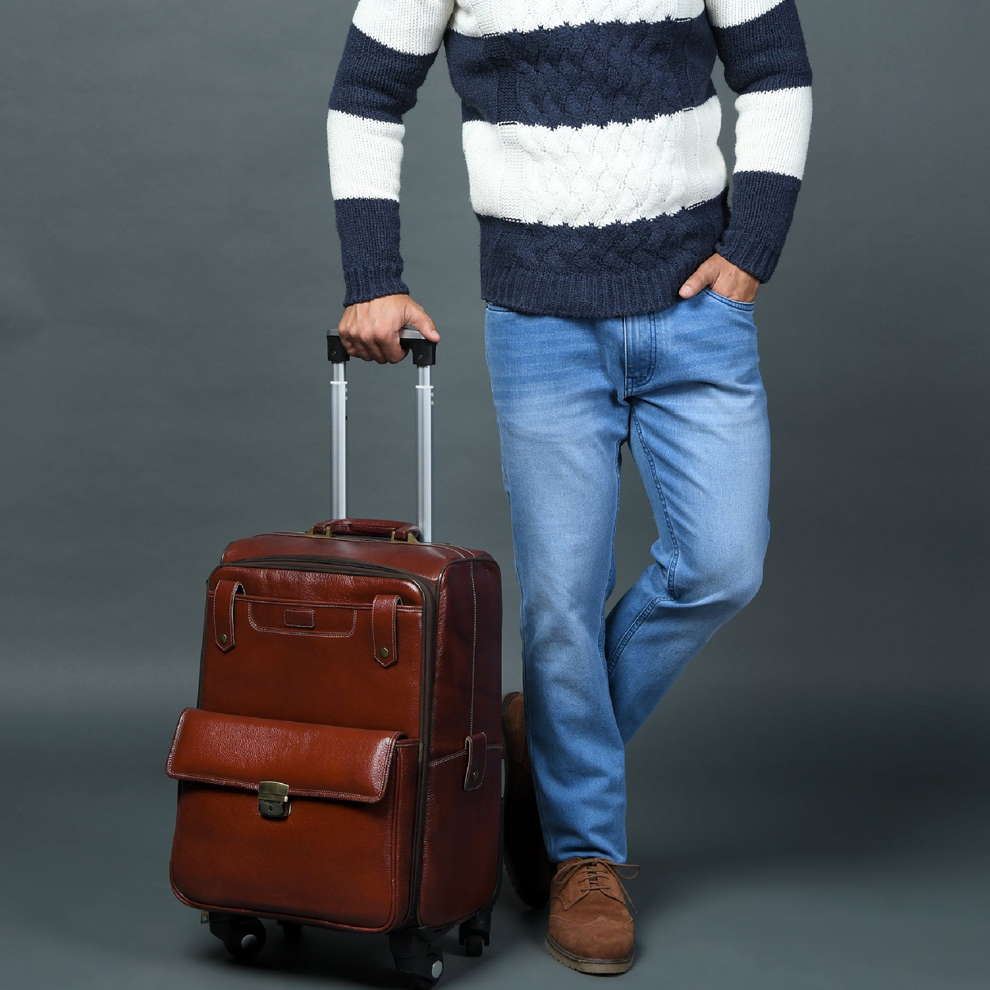 Brown leather carry-on trolley bag with telescoping handle and front strap flap
