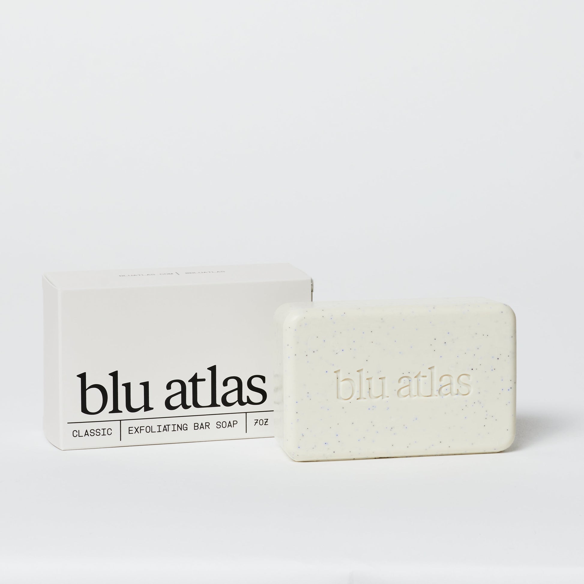 Exfoliating bar soap and box, pale cream bar with blue specks