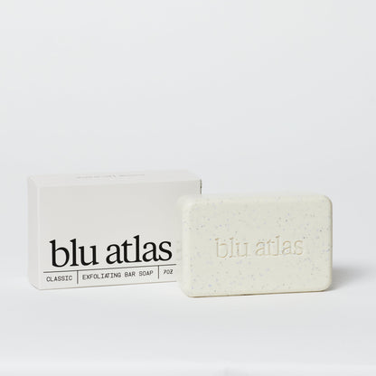 Exfoliating bar soap and box, pale cream bar with blue specks