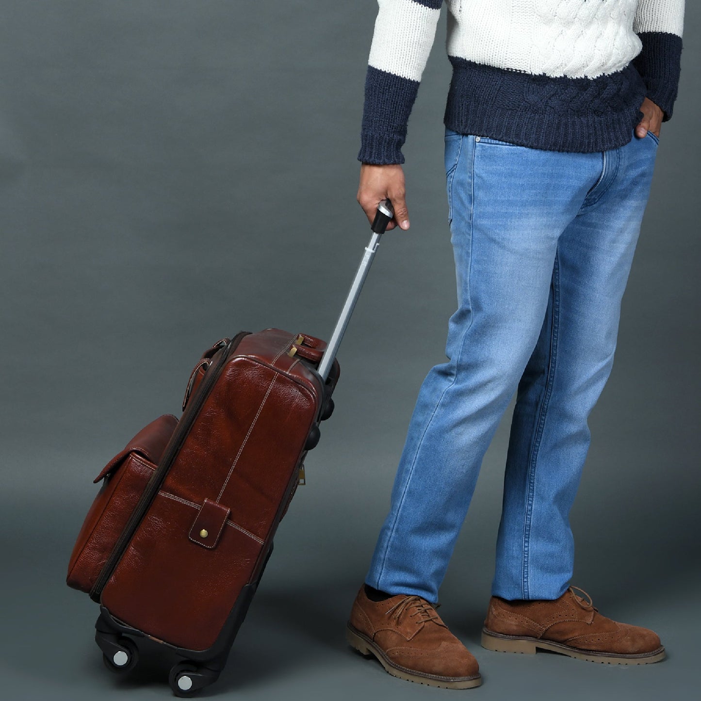 Brown leather carry-on trolley bag with telescoping handle and side buckle strap