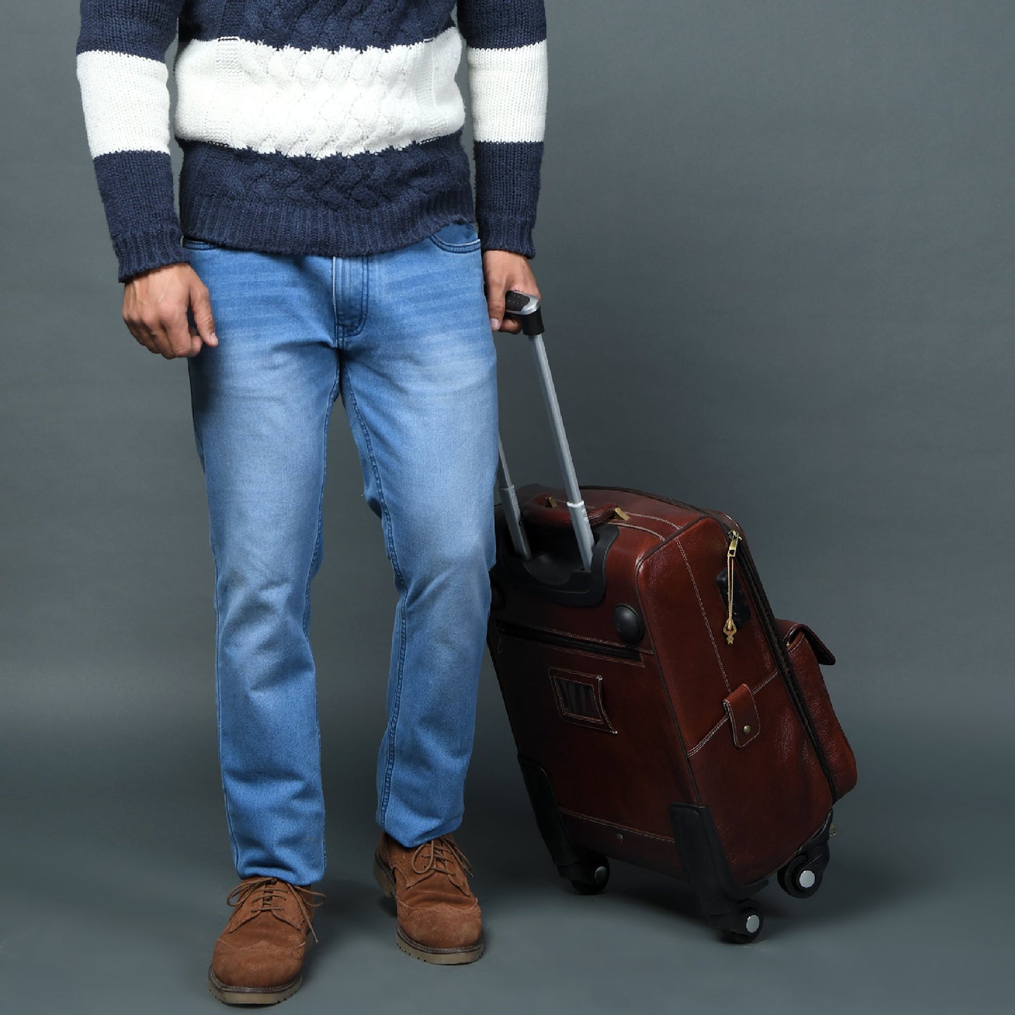 Brown leather carry-on trolley bag with side latches and telescoping handle