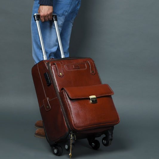 Brown leather carry-on trolley bag with telescoping handle and four spinner wheels