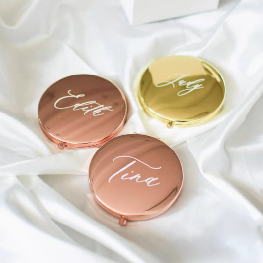 Personalized compact makeup mirrors in rose gold and gold, cursive name engravings.