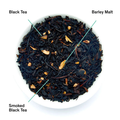 Smoked black tea loose leaves in a dish with visible stems and slices