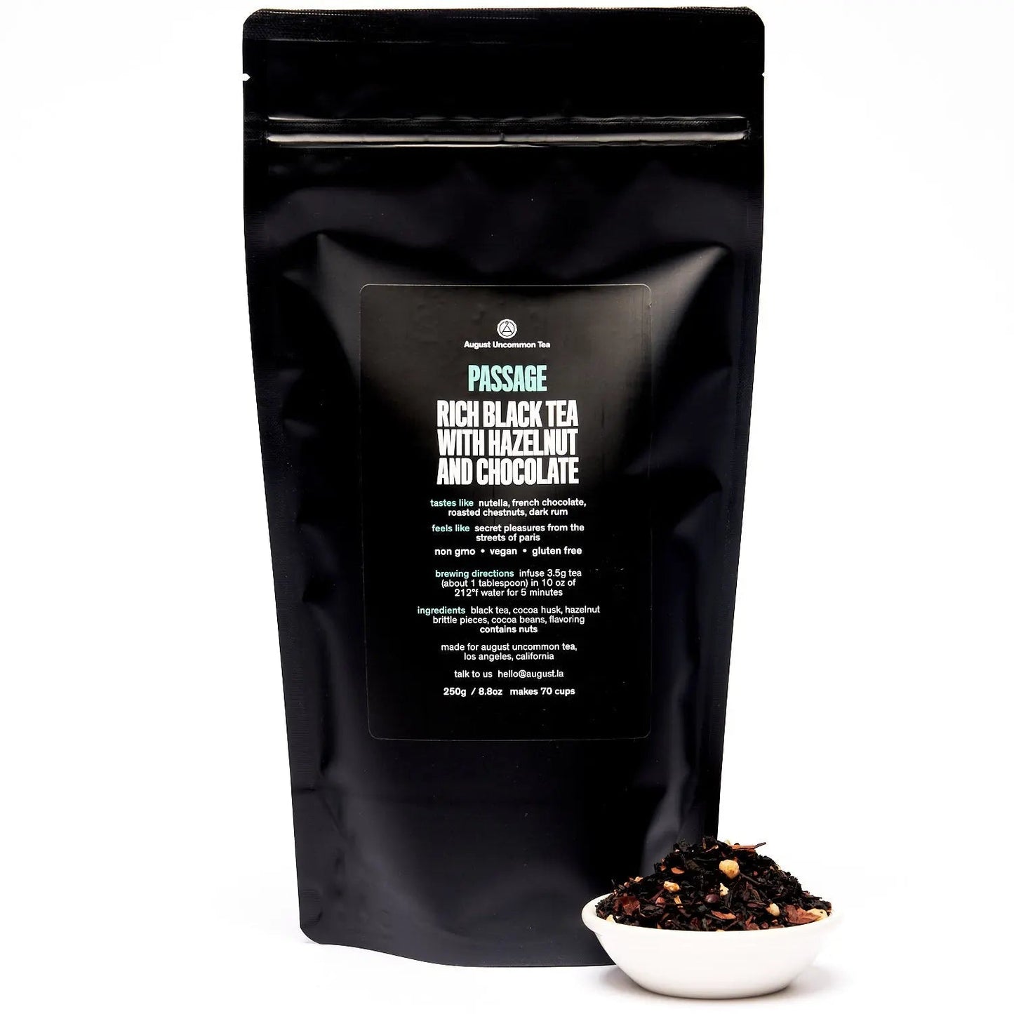 Black tea blend pouch with back panel facing camera and a small bowl of loose tea