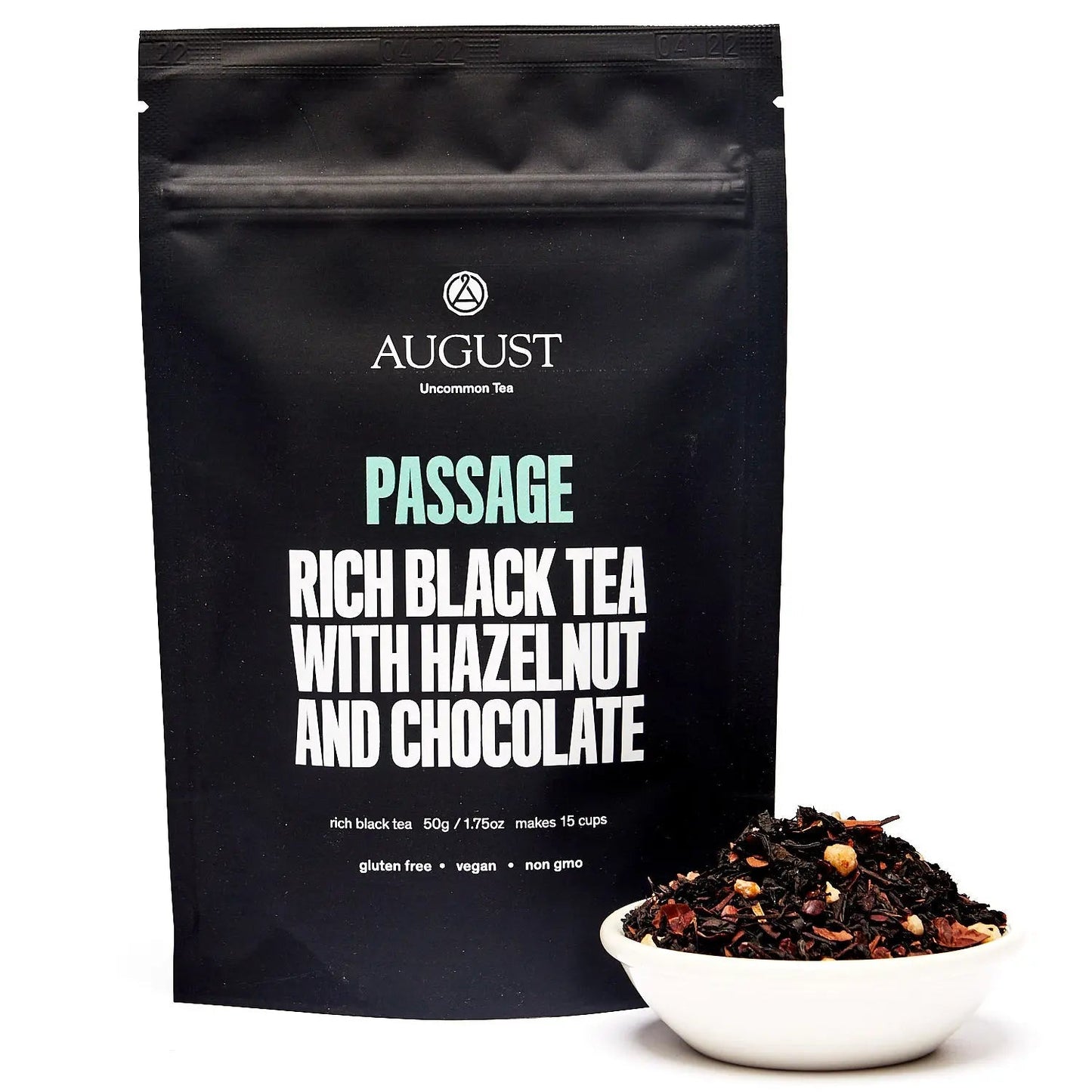 Black tea blend pouch standing upright with a small bowl of loose tea