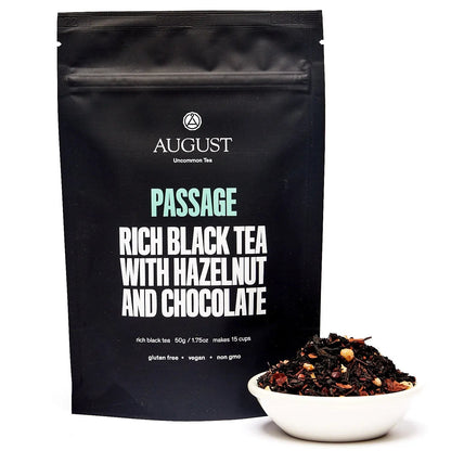 Black tea blend pouch standing upright with a small bowl of loose tea