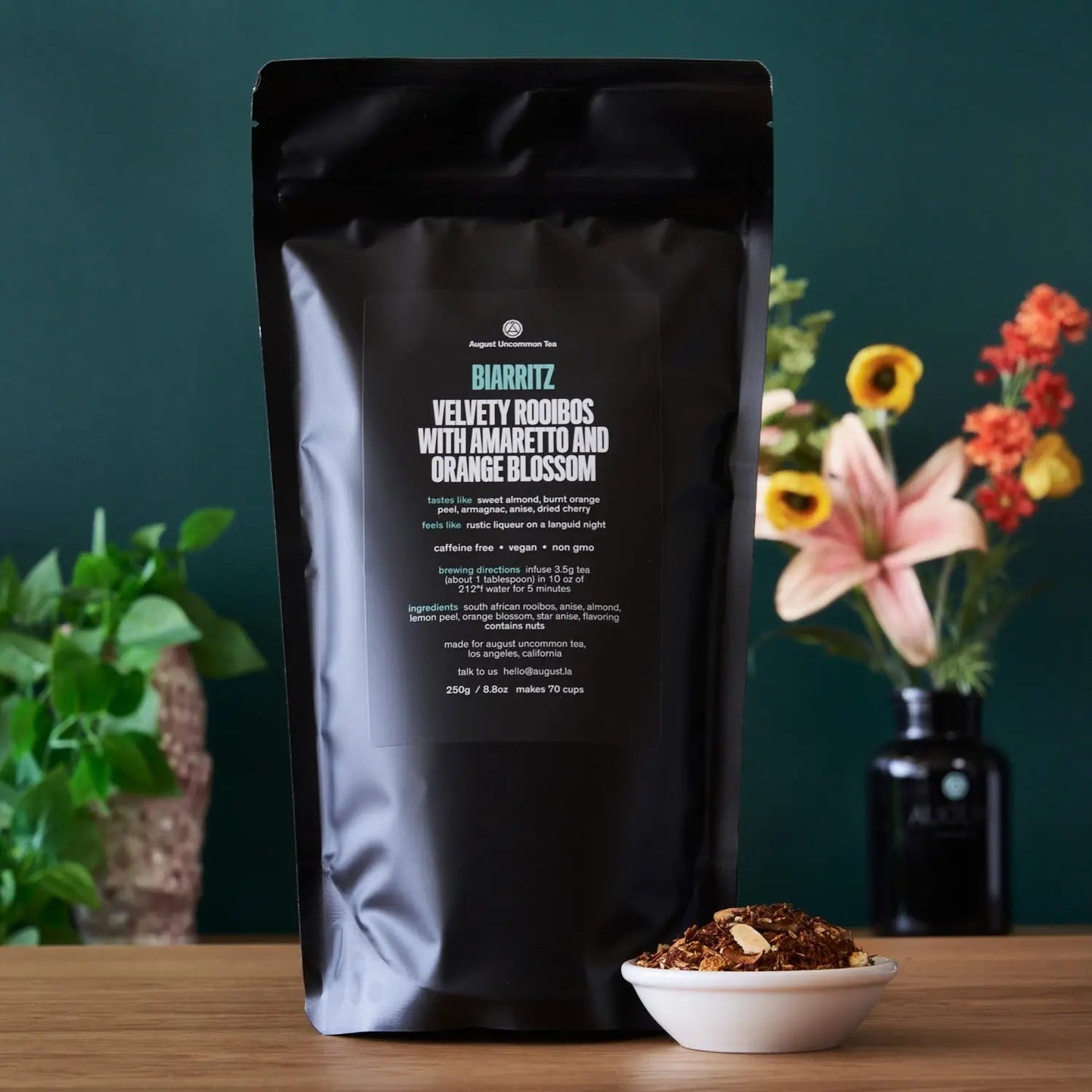 Rooibos tea pouch with product details and bowl of loose tea