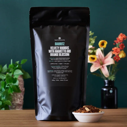 Rooibos tea pouch with product details and bowl of loose tea