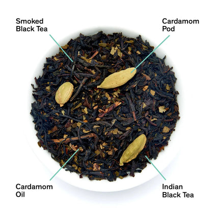 Smoky black tea blend with cardamom pods and cardamom pieces in a bowl
