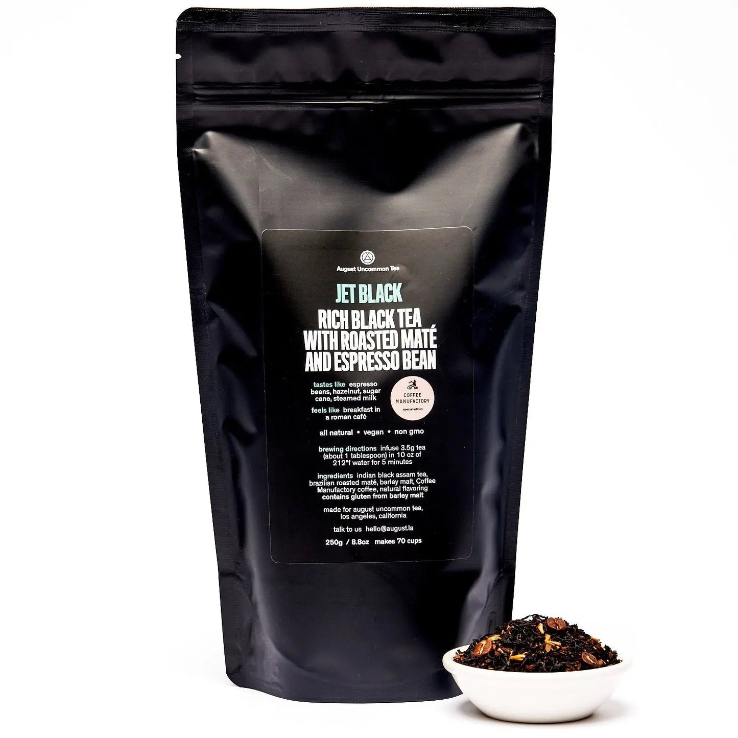 Black tea blend pouch with back label and small bowl of loose tea in front