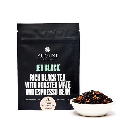 Black tea blend pouch with front label and small white bowl of loose tea on right