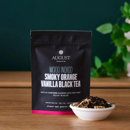 Smoky Orange Vanilla Black tea pouch with a small bowl of loose tea