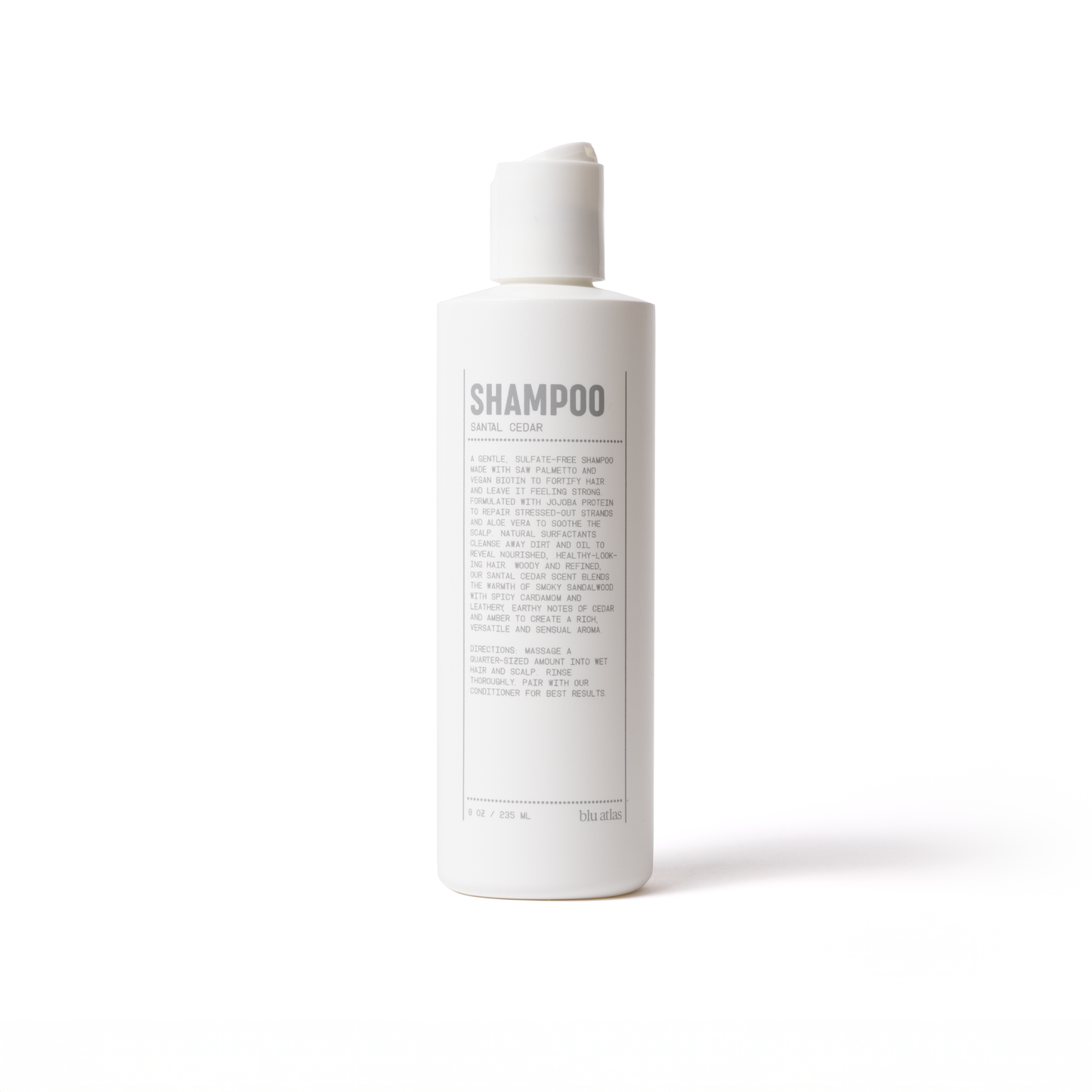 Natural shampoo bottle with back label showing CEDAR scent wording