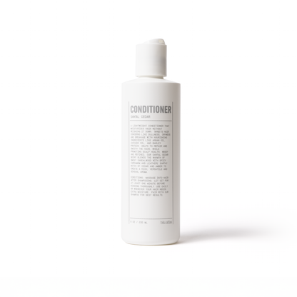 Conditioner bottle with pump, label on back visible
