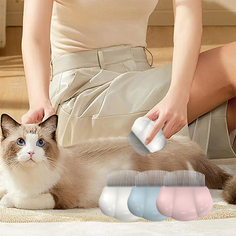 Pet grooming shell comb with metal teeth, shown brushing a small cat