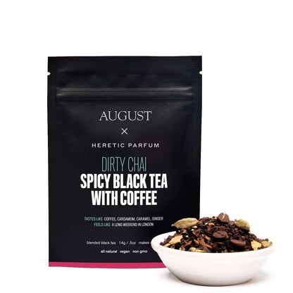 Black tea pouch with small bowl of dark tea leaves and coffee, topped with spices