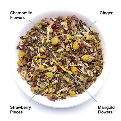 Dried herbal tea blend in bowl: chamomile, ginger, marigold flowers, strawberry pieces