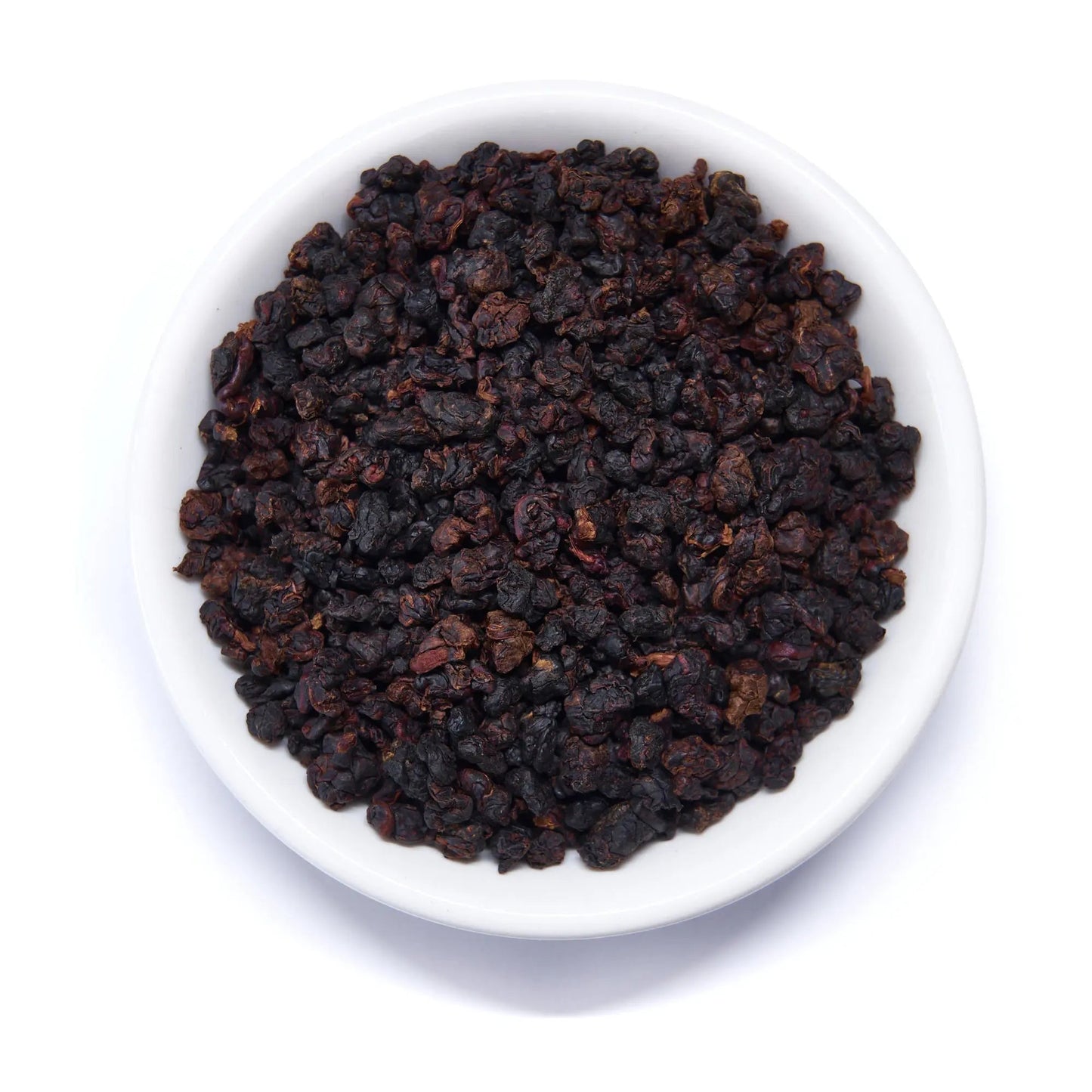 Dark roasted oolong tea leaves in white bowl