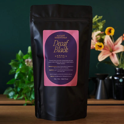 Black tea pouch with pink label showing Decaf Black and Organic