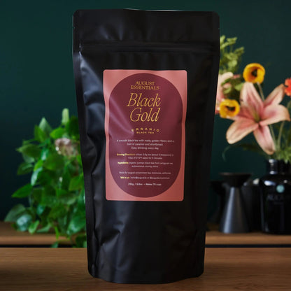 Black tea pouch, August Essentials Black Gold back label on black foil bag