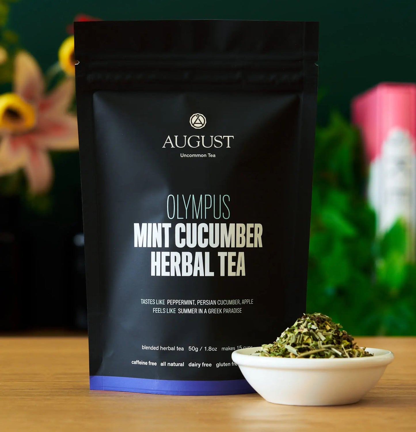 Black herbal tea pouch with mint cucumber label and bowl of dried tea leaves
