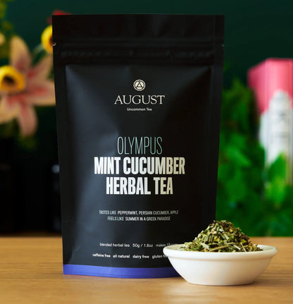 Black herbal tea pouch with mint cucumber label and bowl of dried tea leaves