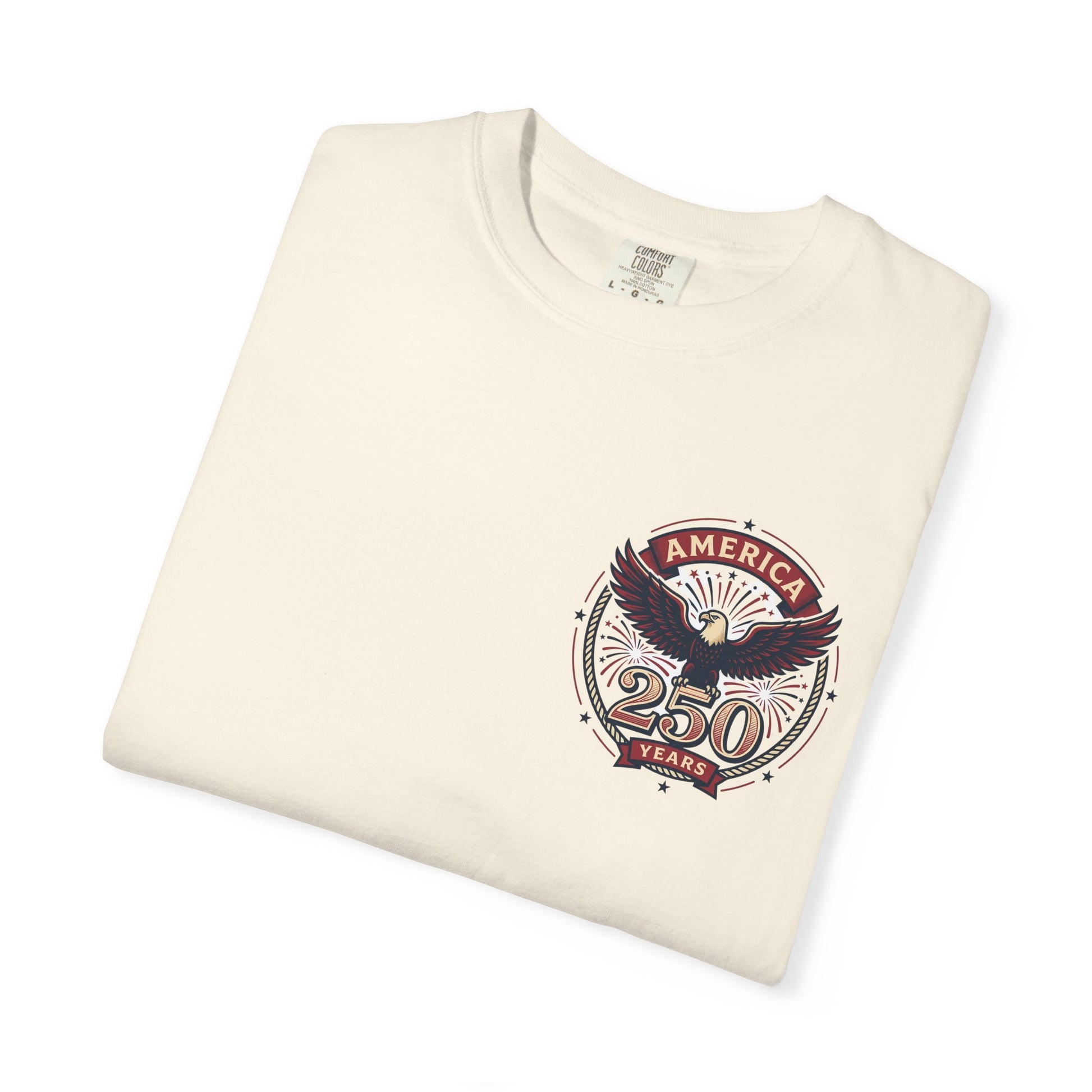 Cream T-shirt with circular "America" eagle emblem and "250 Years" graphic on the chest.