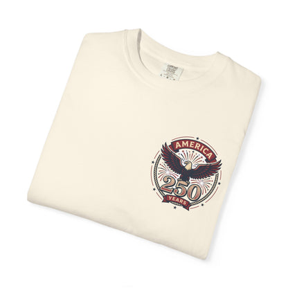 Cream T-shirt with circular "America" eagle emblem and "250 Years" graphic on the chest.