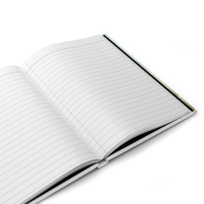 Open hardcover journal showing blank lined pages with black spine edge