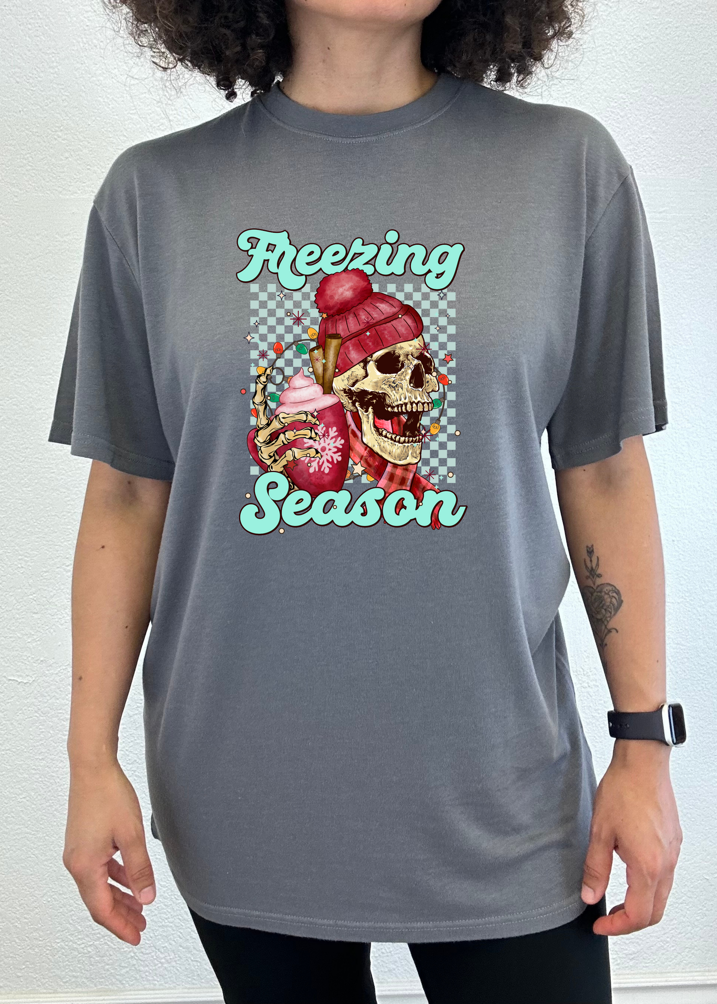 Dark gray short sleeve T-shirt with “Freezing Season” skull graphic on chest.
