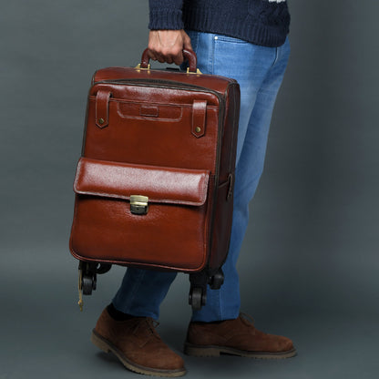 Brown leather carry-on trolley bag with front flap clasp and top carry handle