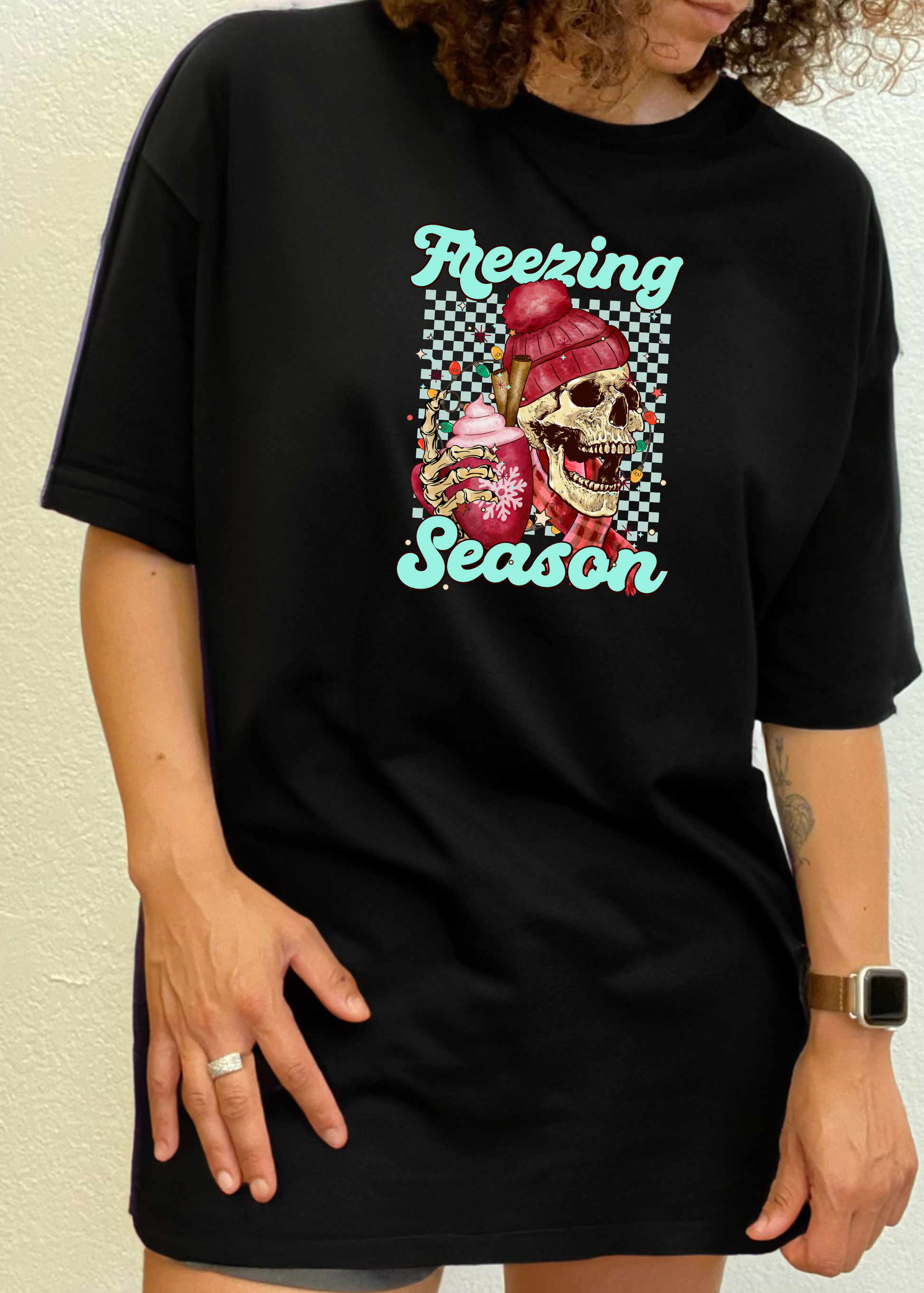 Black short sleeve T-shirt with “Freezing Season” skull graphic on chest.