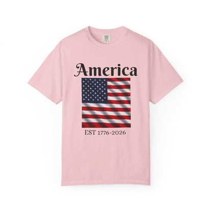 Pink crewneck T-shirt with "America" text, American flag, and EST 1776-2026
