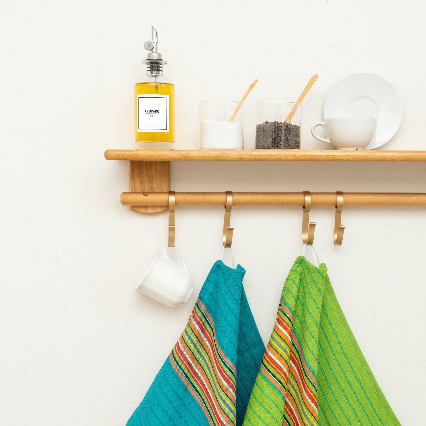 Striped kitchen towels hanging, blue-and-green rainbow stripes