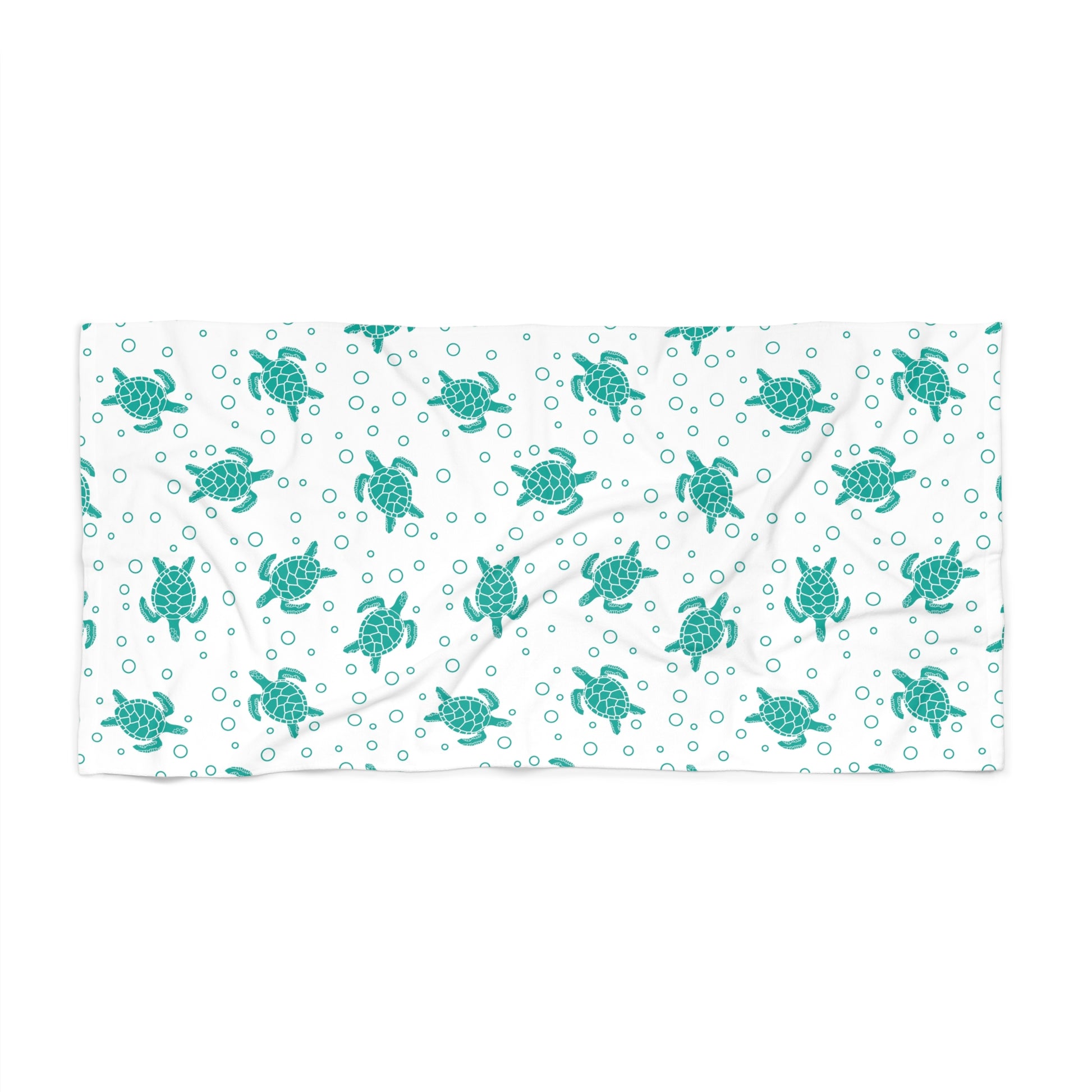 Beach towel with teal sea turtle pattern on white, rectangular folded layout