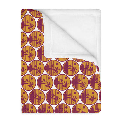 Velveteen throw blanket with orange pumpkin circle pattern on brown base