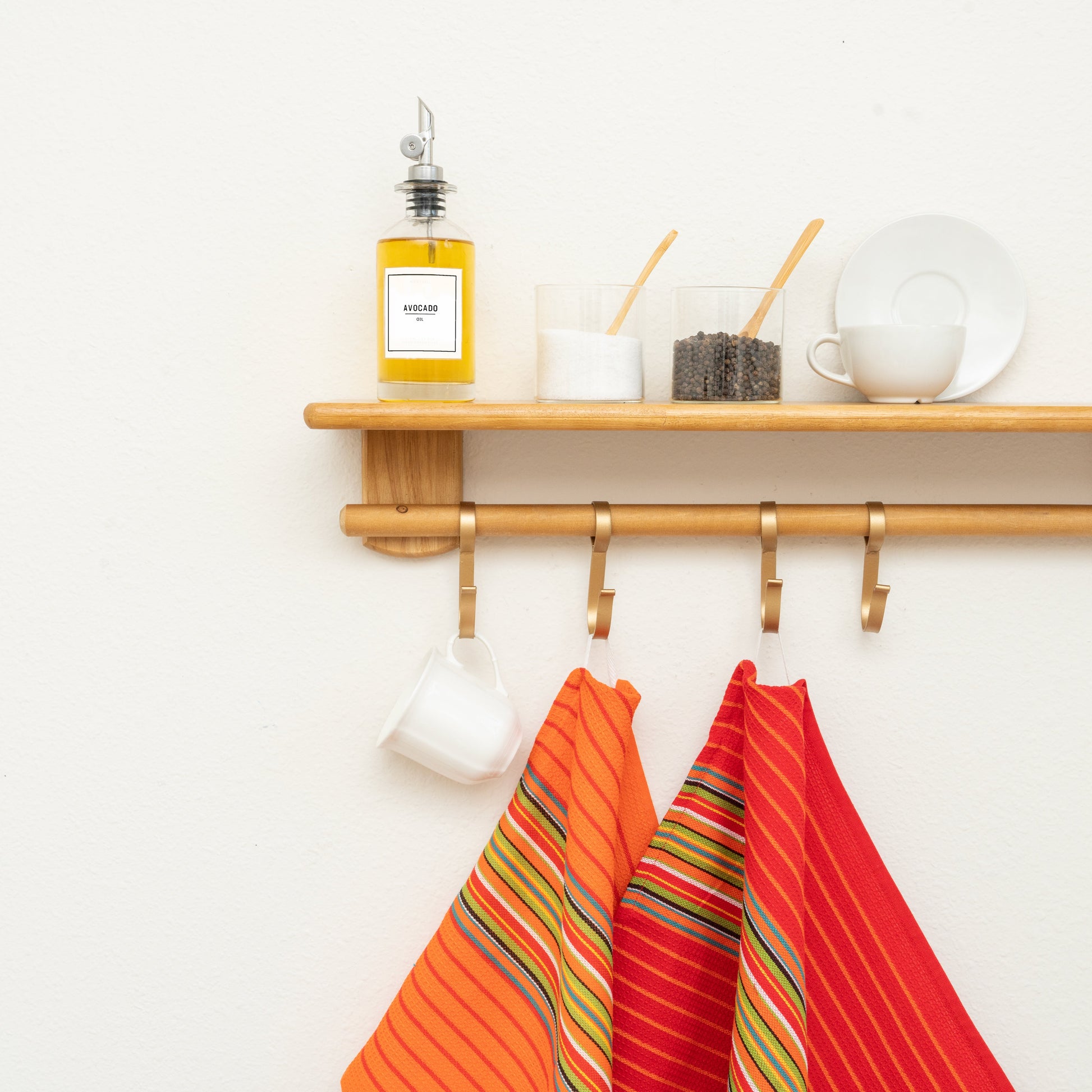 Striped kitchen towels hanging, red-and-orange rainbow stripes