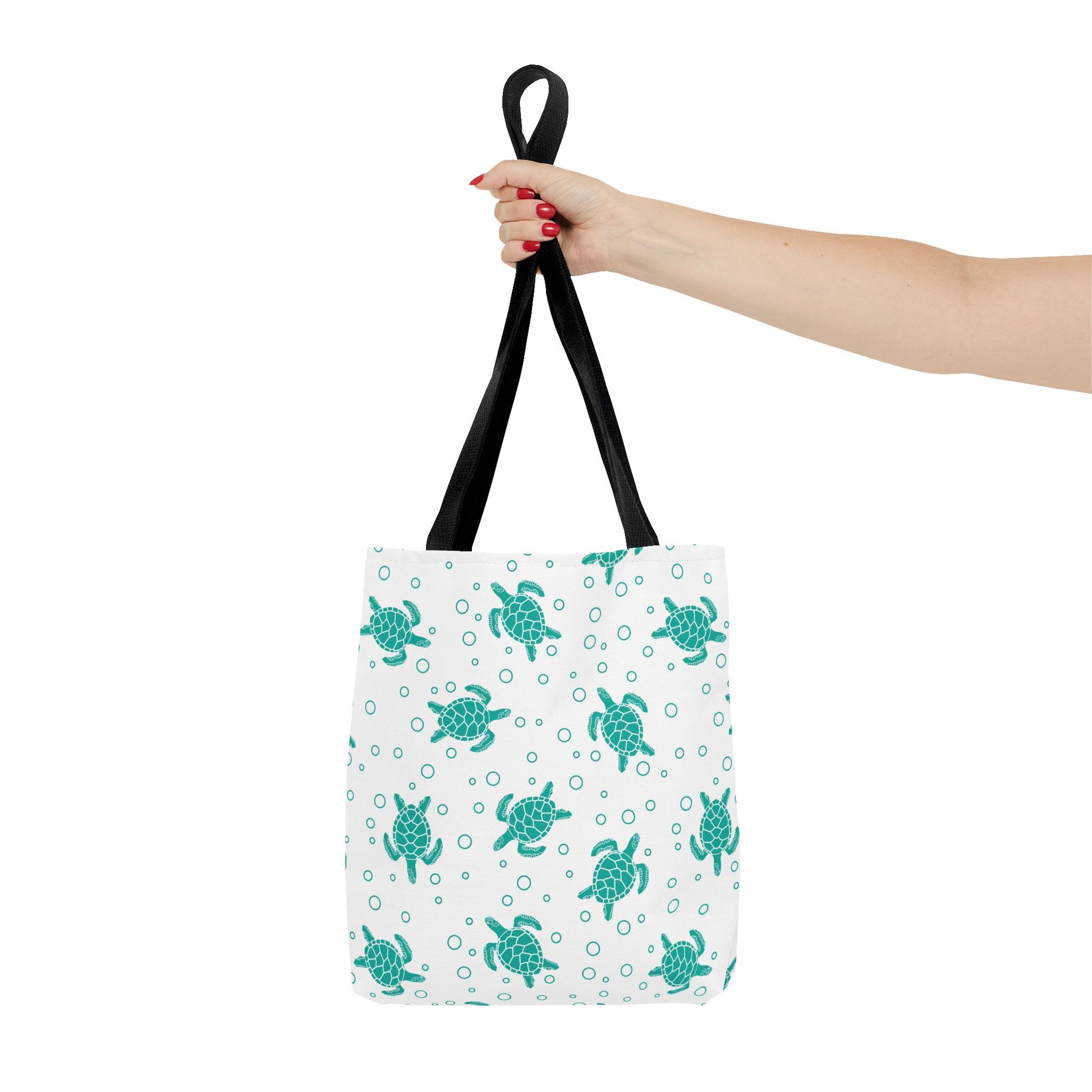 Sea turtle pattern tote bag with teal repeating turtles and black carry handles