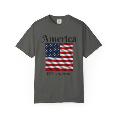 Dark gray T-shirt with “America” over US flag and “EST 1776-2026” graphic on front
